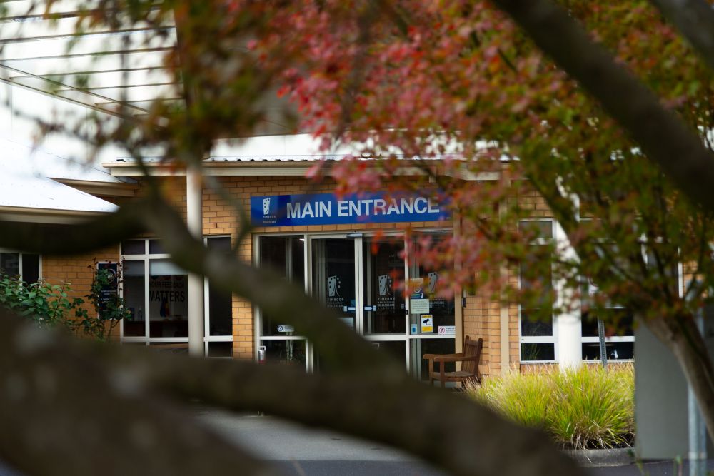 Timboon & District Healthcare Service A single-storey brick healthcare building with an accessible ramp, garden beds and signage for Timboon and District Healthcare Service at the entrance.