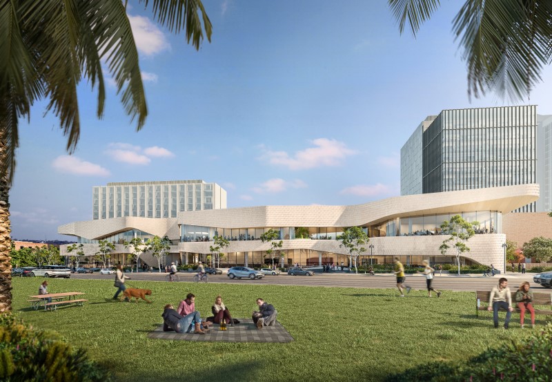 Artist impression of the front view of the exhibition centre, with lush grass lawns with people enjoying a picnic with the centre in the background.