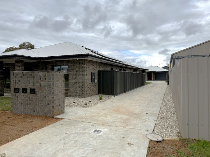 A picture of new brick houses with letterboxes