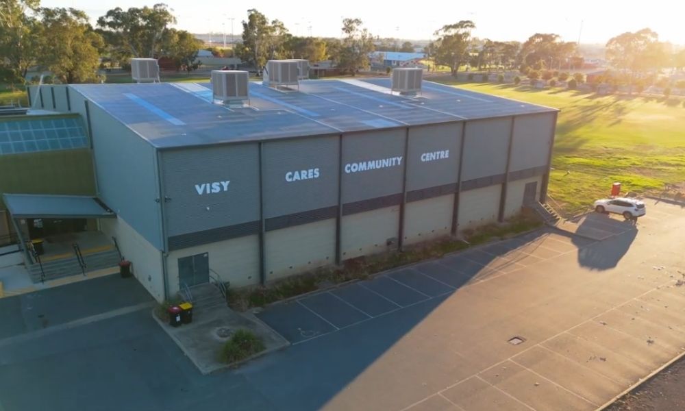 Aerial view of the outside of the VISY Stadium in Shepparton Sport City, with new roof infrastructure and solar panels visible.