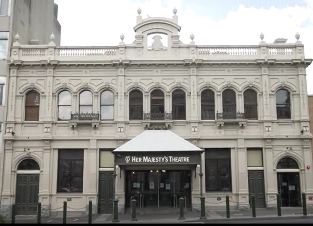 The heritage rendered Façade of Her Majesty’s Theatre in Ballarat featuring double story windows and period design features adorning the roof.