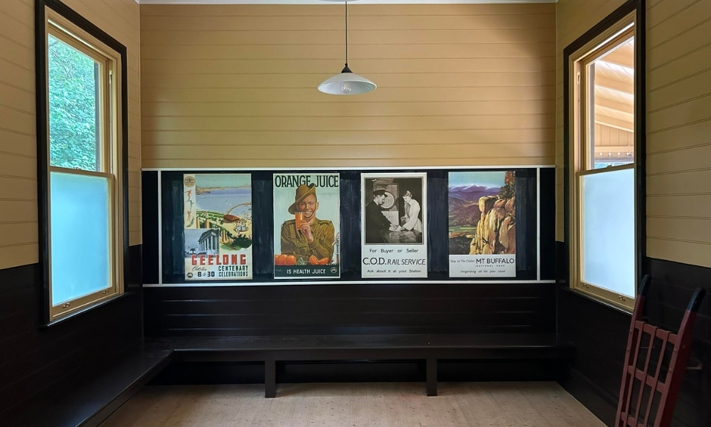 Station interior, updated to be historically accurate. Four posters from the 1930’s can be seen in the centre frame, sitting above a black bench where passengers can wait for the train.