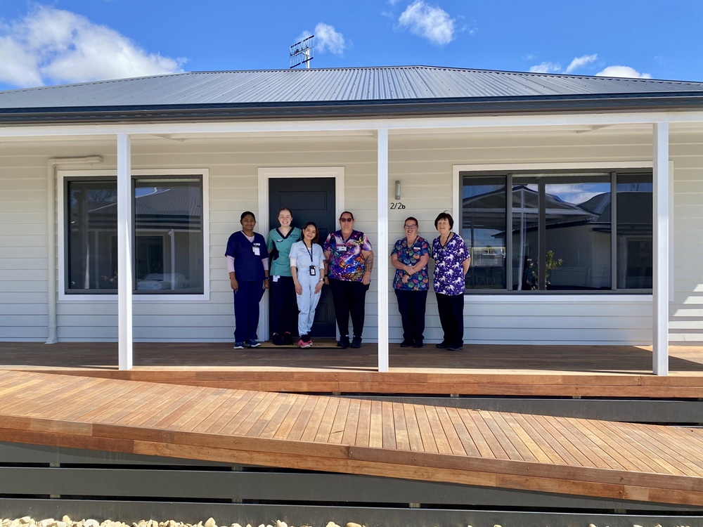 Six Rural Northwest Health Workers standing on the porch of the new duplex worker accommodation building in Hopetoun.
