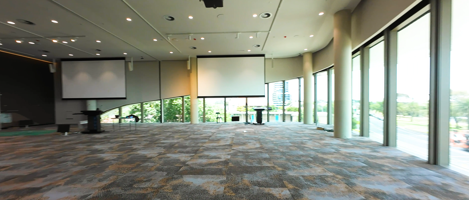 A picture of an event space with windows overlooking the bay