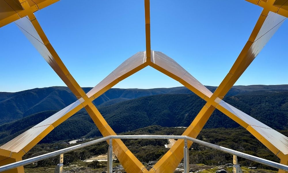 Point-of-view photo taken from the end of the Flower of the Alpine Sun, overlooking the valley and mountain peaks.