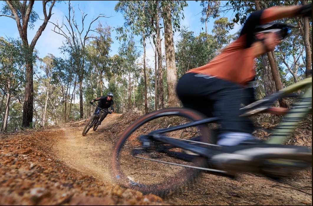A person riding a bike on a trail