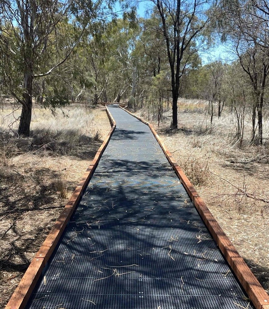 A picture of a new boardwalk connecting the river and town