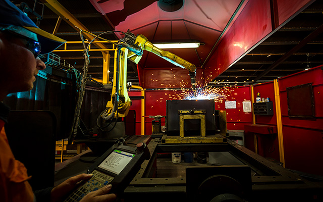 Factory worker operating machinery