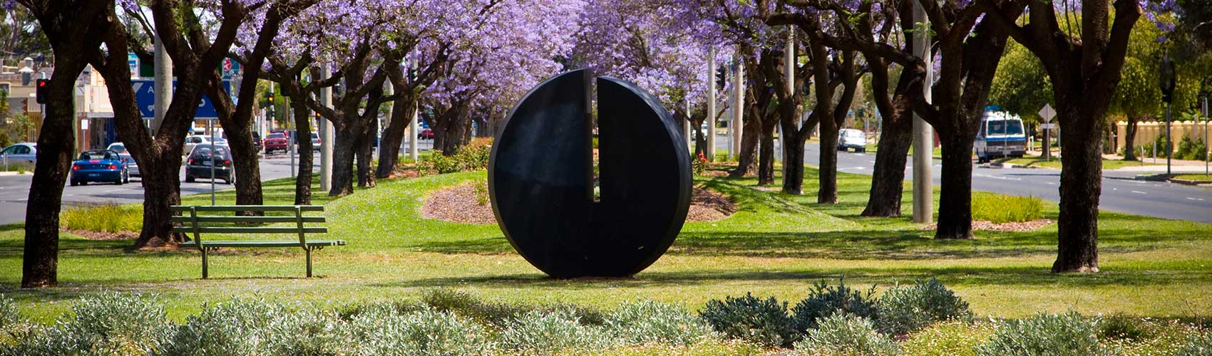 street sculpture and jacaranda trees