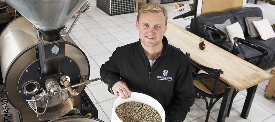 person preparing coffee beans for roasting